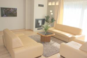 a living room with two couches and a table at Family friendly Apartment Baltic Seaside in Šventoji