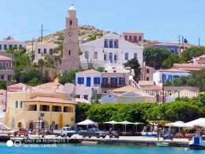 a view of a town with a clock tower at Villa Chrysodimi in Halki