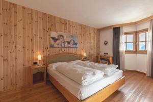 Un pat sau paturi într-o cameră la Garnì Lilly