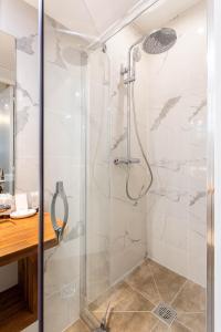 a bathroom with a shower with a glass door at CMG Oberkampf/ Charonne C in Paris