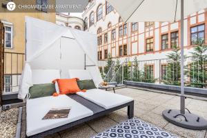 a balcony with a bed and an umbrella at BpR Elite Apartments - Sky Terrace in Budapest