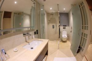 a bathroom with a sink and a toilet at Regenta Central RS Chennai OMR SIPCOT in Chennai +124 photos