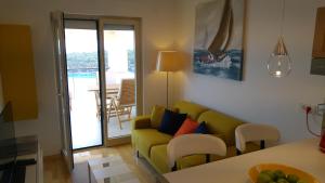 a living room with a couch and a table at Apartment AMMIRARE Rab in Rab