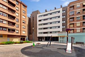 a playground in the middle of a city with buildings at Sercotel Logroño Suites in Logroño