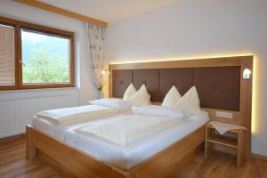 Posteľ alebo postele v izbe v ubytovaní Ferienwohnungen Greiderer Walchsee + 19 fotografií