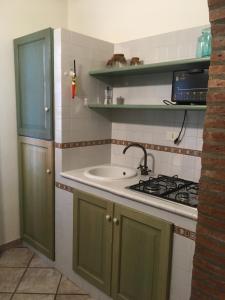 a kitchen with a sink and a stove at Sogno nel blu in San Vito lo Capo