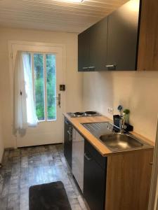 an empty kitchen with a sink and a window at Kleines Nest im Zentrum, eigener Eingang, Parkplatz, kostenloses Wlan in Dornbirn