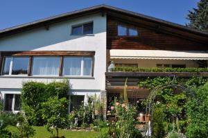 a house with a garden in front of it at Im Röseligarten in Wolfhausen