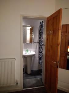 a bathroom with a sink and a mirror at Oxford Road in Macclesfield
