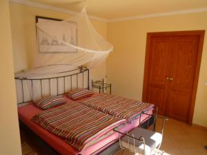 a bedroom with a bed with a mosquito net on it at Traumvilla Encina in Canyamel +56 photos
