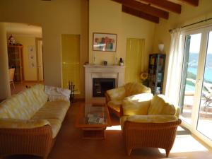 a living room with two couches and a fireplace at Traumvilla Encina in Canyamel