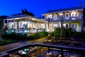 a house with a swimming pool at night at Plumwood Inn - Solar Power in Franschhoek
