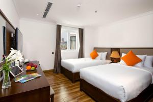 Postel nebo postele na pokoji v ubytování Roliva Hotel & Apartment Danang