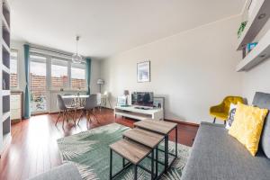 a living room with a couch and a table at Apartamenty Sun&Snow Marina Primore in Gdańsk