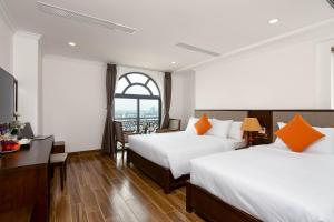 Postel nebo postele na pokoji v ubytování Roliva Hotel & Apartment Danang