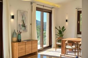 a dining room with a table and a window at Villa Diamond by Cap Vermell Estate in Canyamel