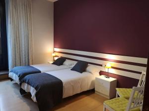 Postel nebo postele na pokoji v ubytování Hostal San Martin