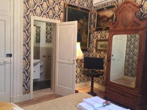 a room with a mirror and a tv on a wall at Palazzo Laguardia in Fasano +69 photos