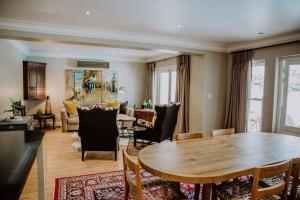a living room with a table and chairs at Franschhoek Village House in Franschhoek