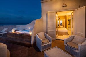 a villa with a pool and a bedroom at Therasia Resort Sea and SPA - The Leading Hotels of the World in Vulcano