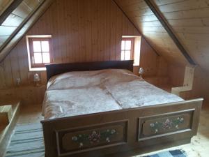a bedroom with a bed in a wooden attic at Ferienhaus Rustica in Rohrbach am Kulm