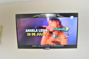 a television screen with a picture of a woman on it at BsAs Platino Apart in Buenos Aires