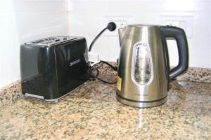 a toaster and a toaster sitting on a kitchen counter at BsAs Platino Apart in Buenos Aires