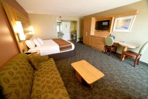 a large hotel room with a bed and a desk at DeSoto Beach Hotel in Tybee Island