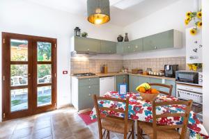 a kitchen with a table with a bowl of fruit on it at Luigino B&B Intero Appartamento in Pisa