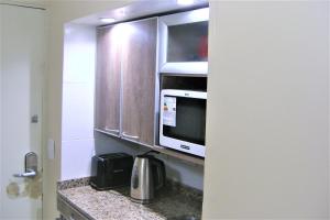 a kitchen with a microwave and a counter top at BsAs Platino Apart in Buenos Aires