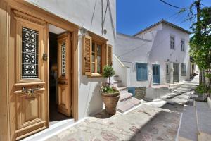a building with a wooden door and a street at Lela's House in Hydra