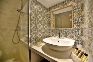 a bathroom with a sink and a mirror at Lela's House in Hydra