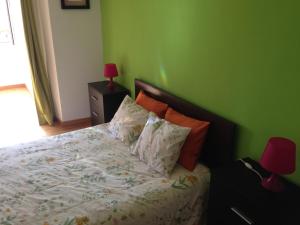 a bedroom with a bed with a green wall at ap. con encanto in Haro