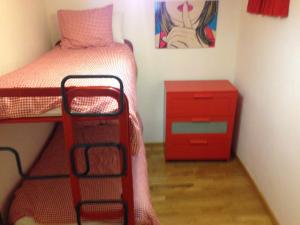 a small bedroom with a bed and a red dresser at ap. con encanto in Haro