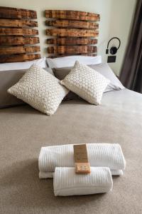 two white pillows on a bed with a tag on it at Meb in Riomaggiore