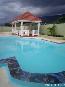 a large swimming pool with a gazebo at Eve's Rockaway Villa in Alligator Pond Village