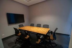 a conference room with a table and a flat screen tv at Tierra Viva Miraflores Centro in Lima