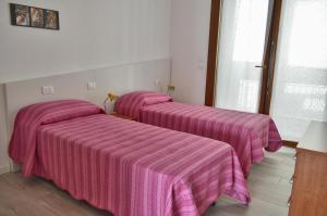 Postel nebo postele na pokoji v ubytování Casa Comisso