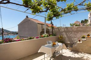 a table on the roof of a house at Apartment Meet & Greet in Dubrovnik