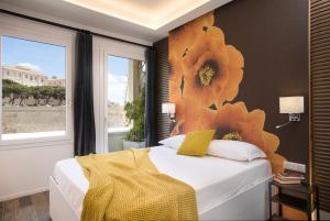 a bedroom with a bed with a flower mural on the wall at Vista Suites - Piazza Yenne in Cagliari