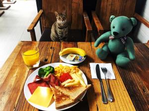 a teddy bear sitting next to a table with a plate of food at Lakeside Inn in Guilin +18 photos
