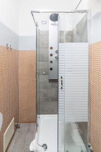 a shower with a glass door in a bathroom at Monti49 GuestHouse in Rome