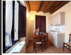 a kitchen with a table and chairs in a room at Sun Moon in Monteprandone