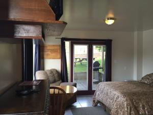 a bedroom with a bed and a sliding glass door at Sauble River Marina and Lodge Resort in Sauble Beach