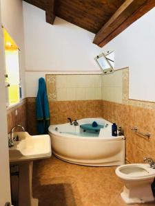 a bathroom with a tub and a toilet and a sink at La Bella di Lamezia (Appartamento) in Lamezia Terme