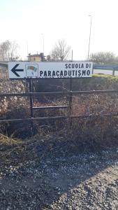 a street sign on a fence next to a road at Appartamento Ai Tigli in Caorle