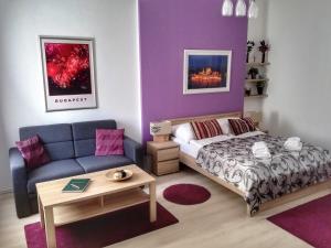 A bed or beds in a room at ABT Apartments Karoly