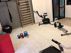 ein Zimmer mit einem Fitnessraum mit einem Laufband und einem Heimtrainer in der Unterkunft Hotel Della Motta in Bellaria-Igea Marina