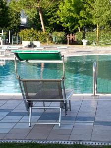 a boat sitting on top of a swimming pool at Appartamento Ai Tigli in Caorle +16 photos