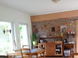 a dining room with a brick wall and a table and chairs at Kleine Pension in Ueckermünde